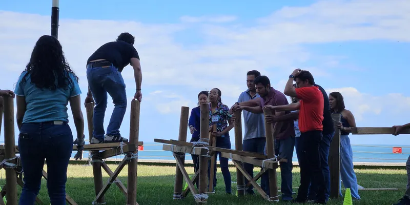 Participantes realizando una dinámica outdoor de team building en equipo